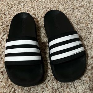 Black with white Adidas slides, size 3 boys.
